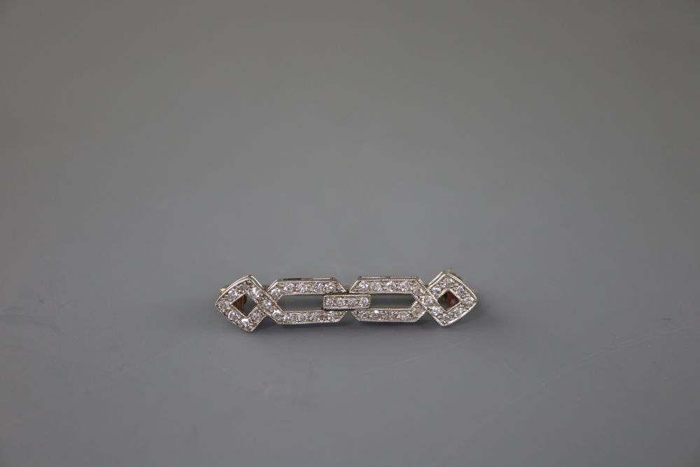 A 1920s white metal and diamond set openwork brooch, 31mm, gross 2.8 grams, with a Tessier box.